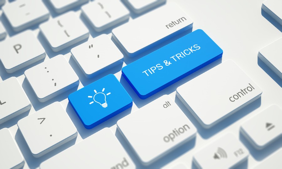 A close-up shot of a computer keyboard which has two custom keys showing a lightbulb icon and the phrase 'Tips and tricks'